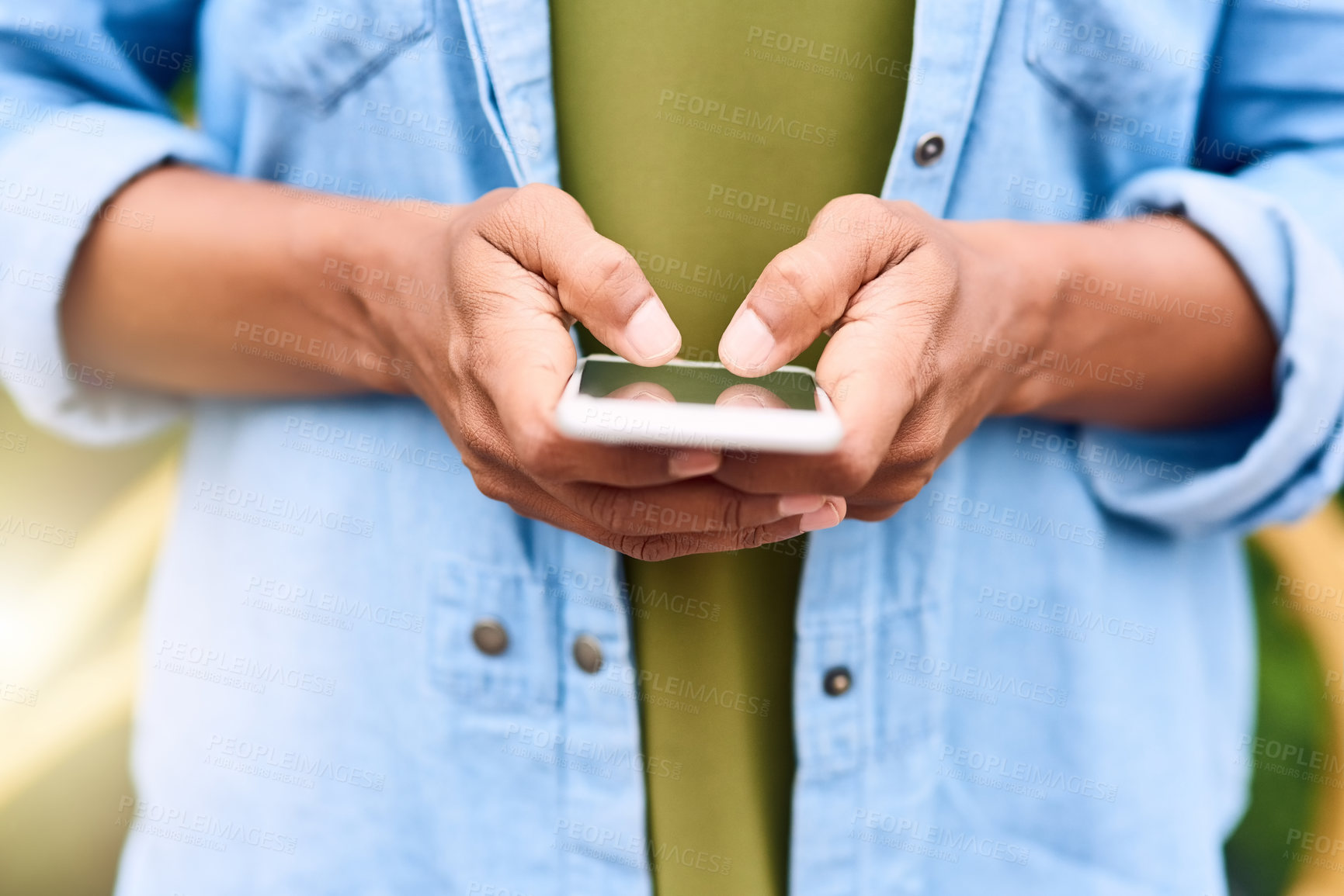 Buy stock photo Cropped shot of an unrecognizable woman using her cellphone while in the city