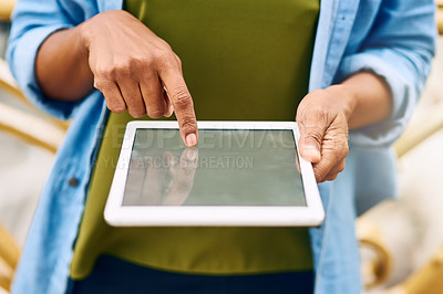 Buy stock photo Cropped shot of a woman using a digital tablet while out in the city