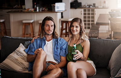 Buy stock photo Portrait of an affectionate young couple chilling on the sofa together at home