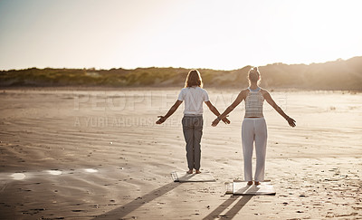 Buy stock photo Rearview shot of an unrecognizable couple practising yoga on the beach