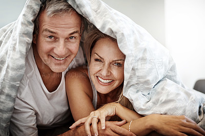 Buy stock photo Shot of an affectionate couple spending the day in bed