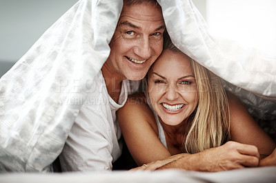 Buy stock photo Shot of an affectionate couple spending the day in bed