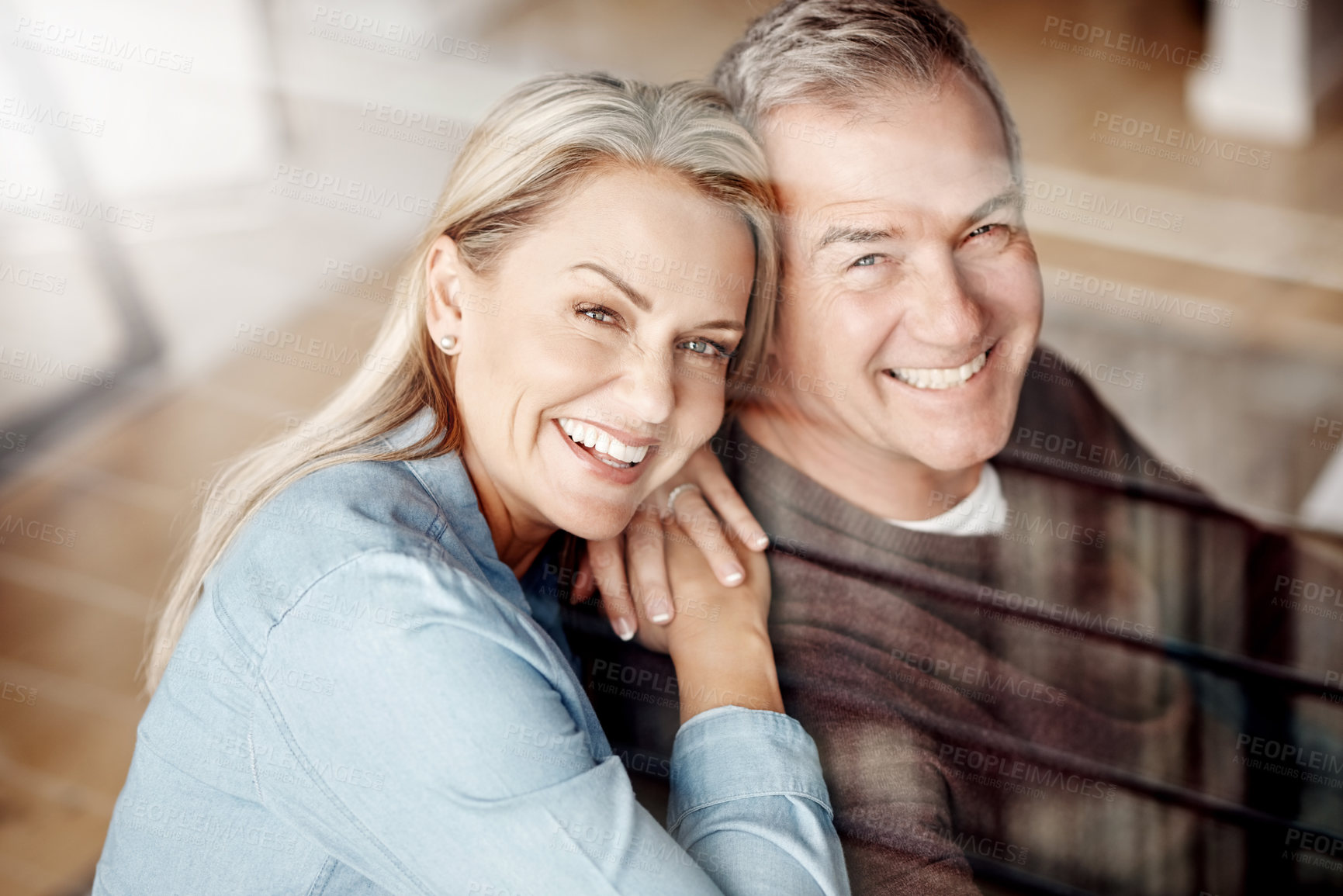 Buy stock photo Shot of an affectionate mature couple relaxing together at home