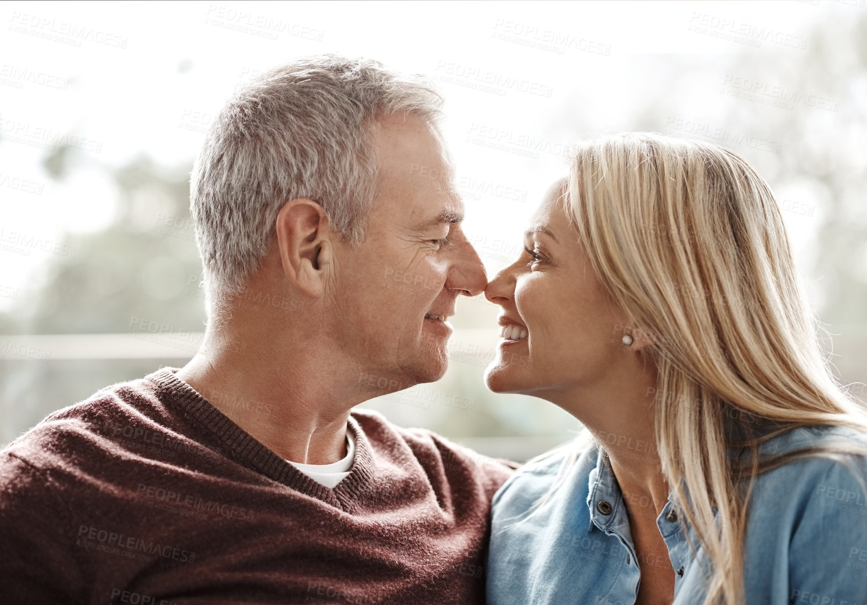 Buy stock photo Shot of an affectionate mature couple sharing a romantic moment at home