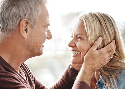 Buy stock photo Shot of an affectionate mature couple sharing a romantic moment at home