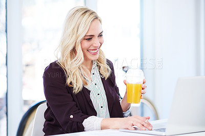 Buy stock photo Cropped shot of an attractive young businesswoman drinking orange juice while working in her office
