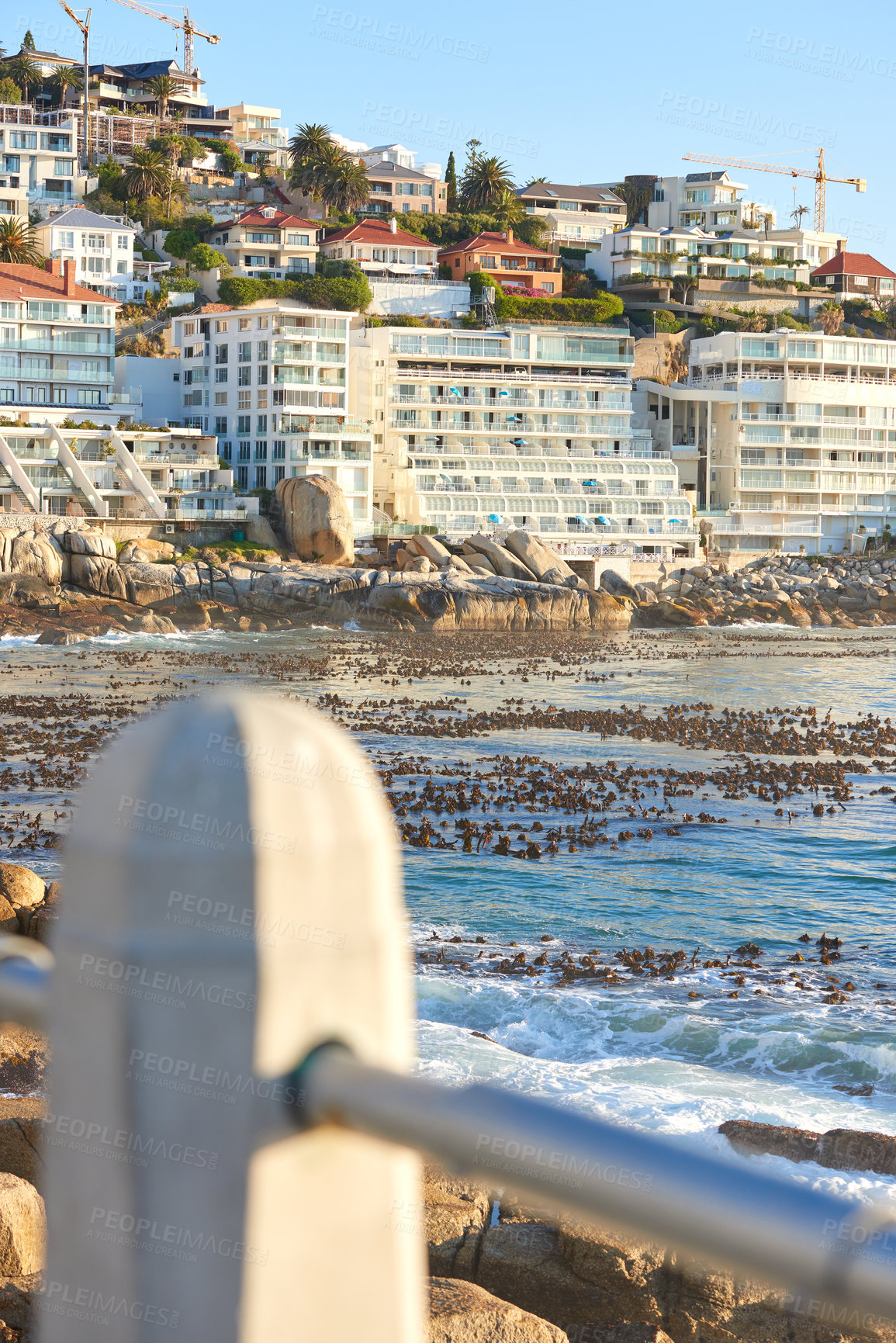 Buy stock photo Clifton, Cape Town, South Africa panorama seascape with clouds, blue sky, Fancy hotels, and apartment buildings in the background. Housing development overlooking the beautiful blue ocean peninsula