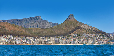 Buy stock photo Panorama seascape with clear blue sky copy space and modern hotel apartment buildings in the background. Sea Point with a view of Lions Head and Table Mountain National Park, Cape Town, South Africa