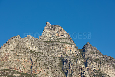 Buy stock photo Landscape view of Table Mountain in Cape Town, South Africa with blue sky and copy space. Low angle of a steep, rough and rugged famous hiking terrain. Risky and dangerous challenge to climb the peak