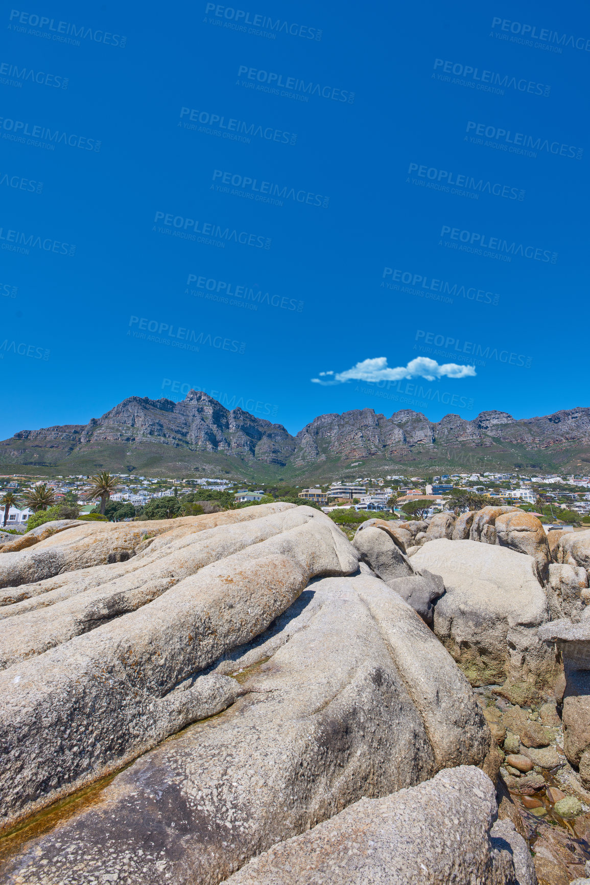 Buy stock photo Low angle view of the Twelve Apostles mountain range in South Africa against a blue sky. Closeup of rocky landscape below a popular tourism attraction. Remote travel location near table mountain