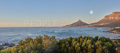 Buy stock photo Landscape view of sea water, mountains and a blue sky with copy space of Lions Head and Table Mountain in Cape Town, South Africa. Calm, serene, tranquil, ocean and relaxing nature scenery at sunrise