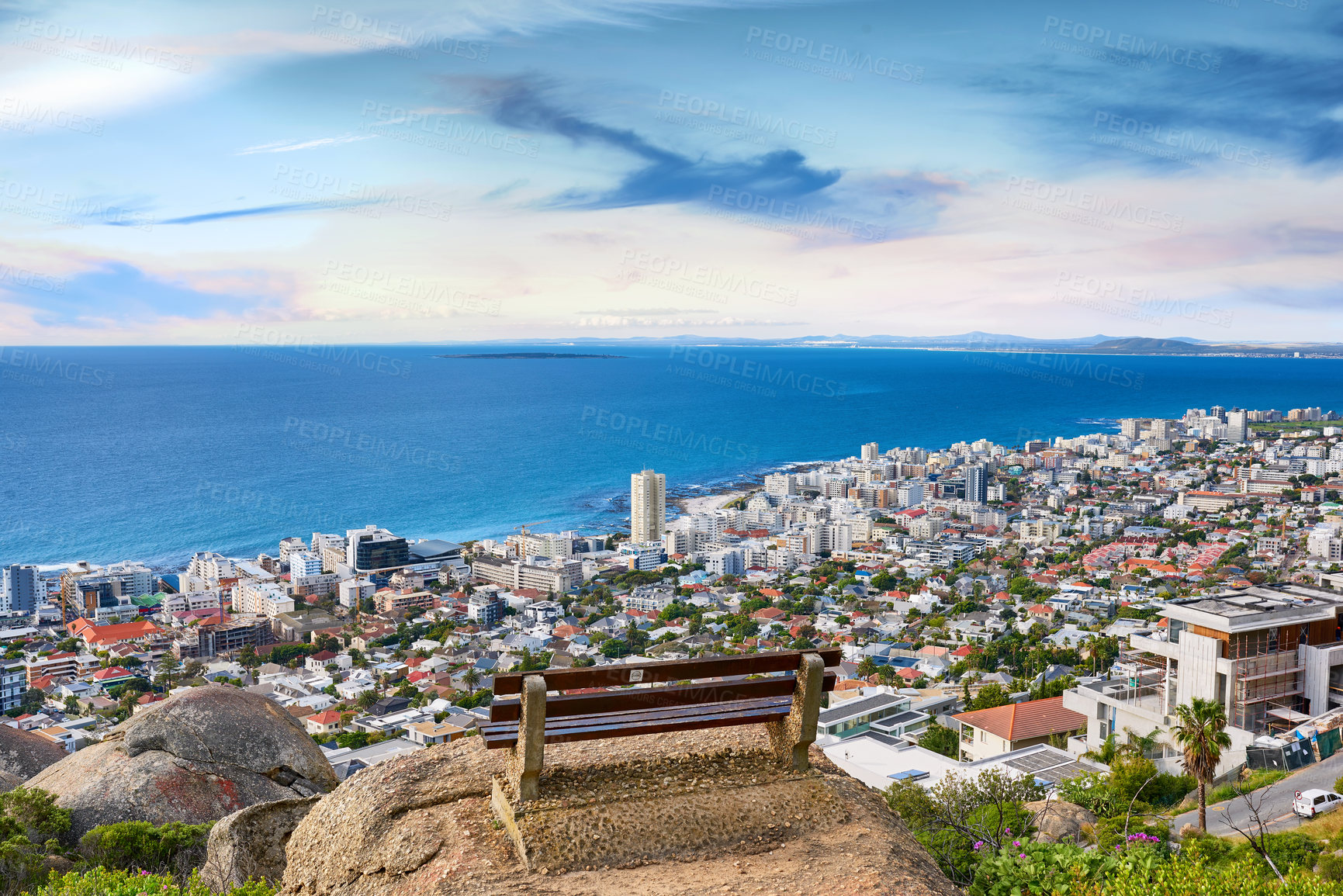 Buy stock photo Above, beach and city with vacation, bench and adventure with environment. Empty, tourism and seaside with buildings, travel and journey with holiday, coastline and earth day for ocean conservation