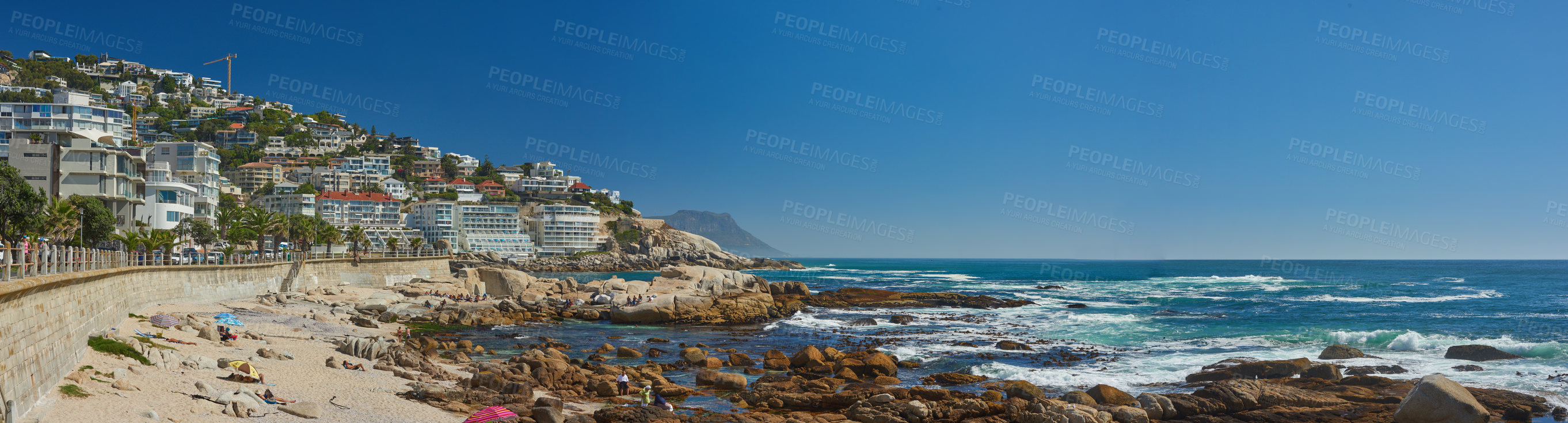 Buy stock photo Landscape of Clifton Beach with a blue sky and copy space in Cape Town, South Africa. Luxury accommodation and holiday apartment buildings with scenic ocean views. Popular tourism summer destination