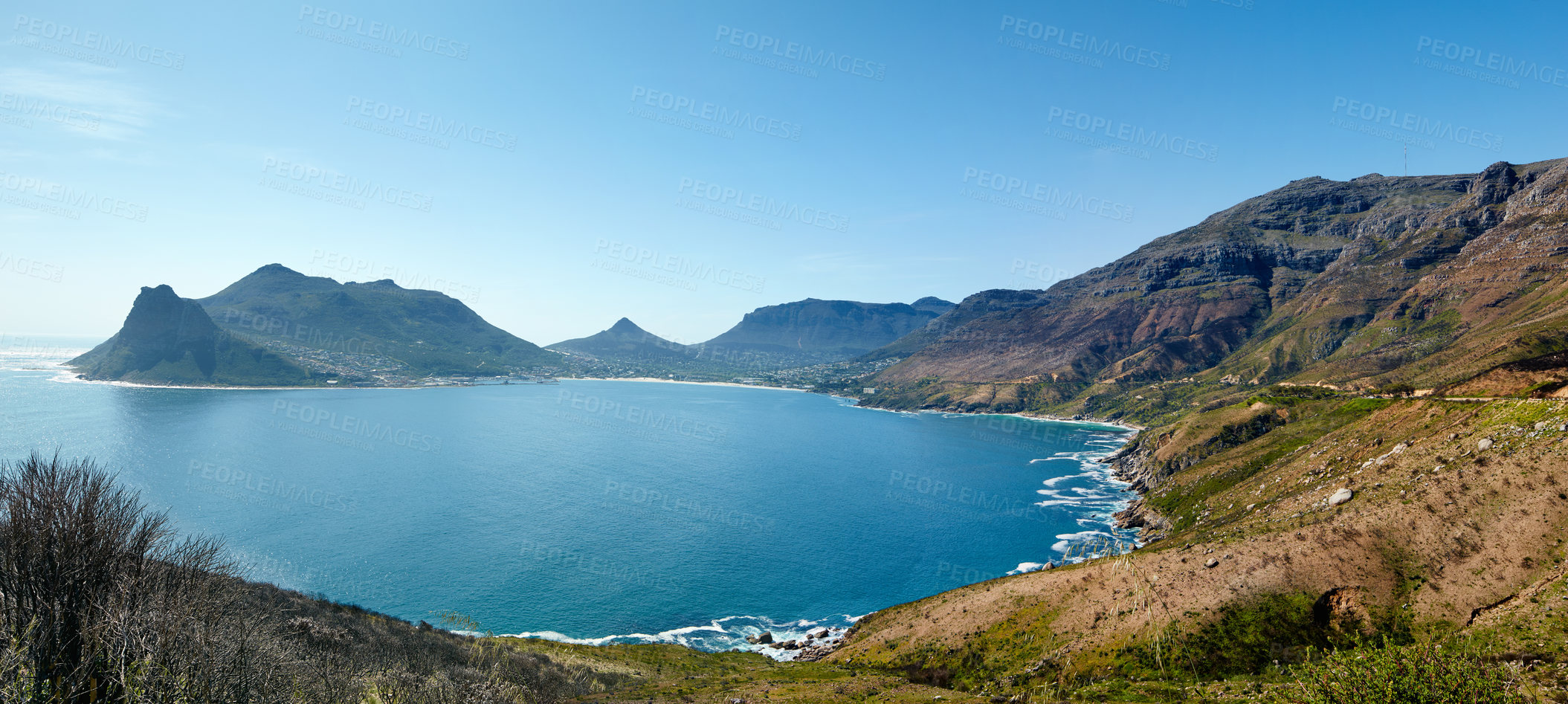 Buy stock photo Wide angle panorama of mountain coastline against clear blue sky in South Africa. Scenic landscape of Twelve Apostles mountain range near a calm ocean in Hout Bay. Popular hiking location from above