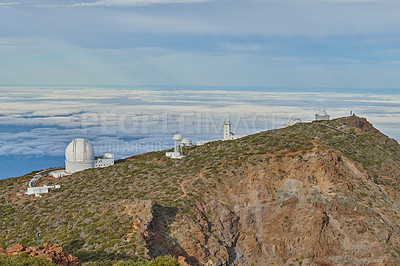 Buy stock photo Roque de los Muchachos Observatory in La Palma. An astronomical observatory on a mountain top with blue sky copy space. Telescope surrounded by greenery and located on an island at the edge of cliff.