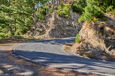 Buy stock photo Curving road or street along a steep mountain valley.  Winding pathway with sharp curve going up the hill with trees on both sides of the trail on a sunny day. Paths of pure adventure. Pine woodland.