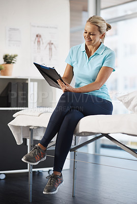 Buy stock photo Full length shot of a mature female physiotherapist working in her office