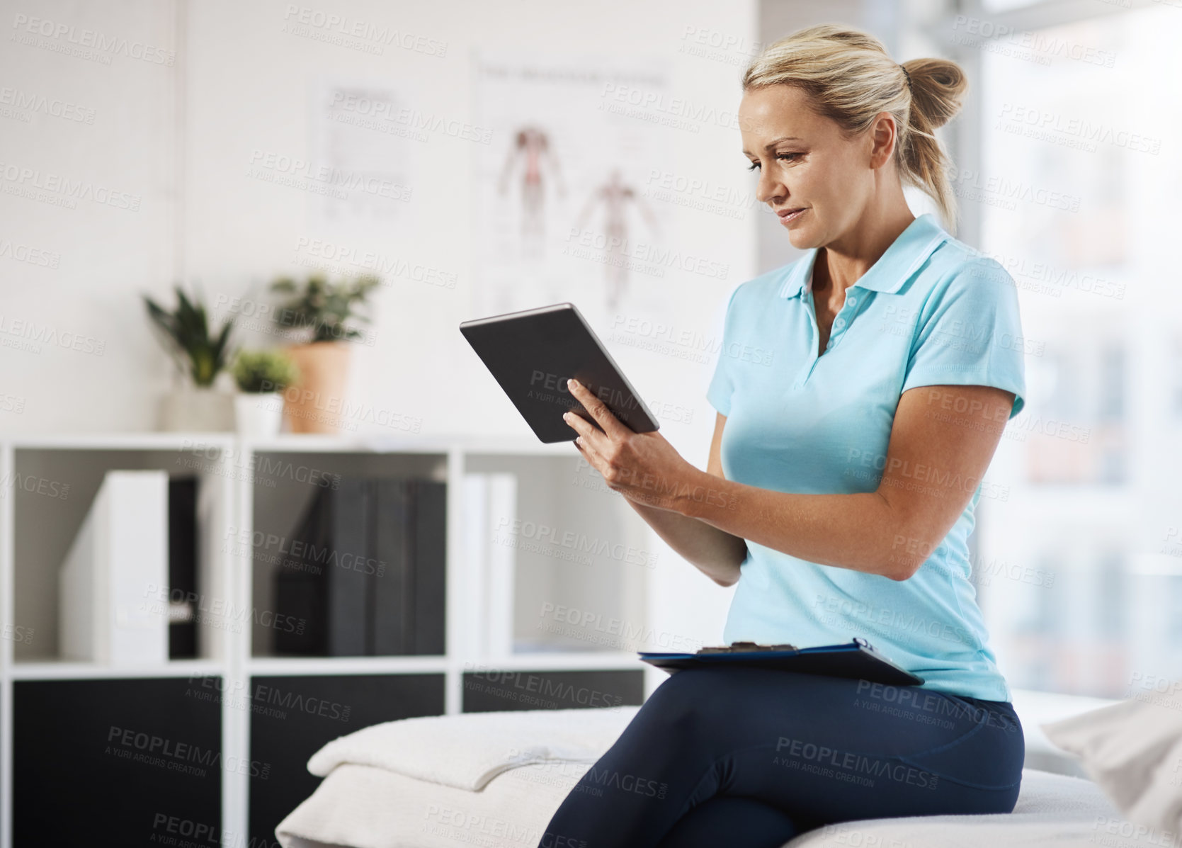 Buy stock photo Physiotherapy, woman and reading in office with tablet, telehealth or appointment schedule. Mature physiotherapist, tech or research in practice for medicare, healthcare app or update client database