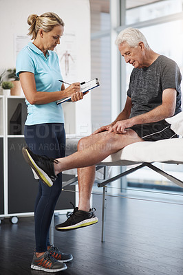Buy stock photo Full length shot of a mature female physiotherapist working with a senior male patient in her office