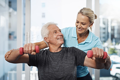 Buy stock photo Cropped shot of a mature female physiotherapist working with a senior male patient in her office