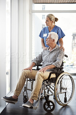 Buy stock photo Full length shot of a mature female nurse and her senior male wheelchair-bound patient in the hospital