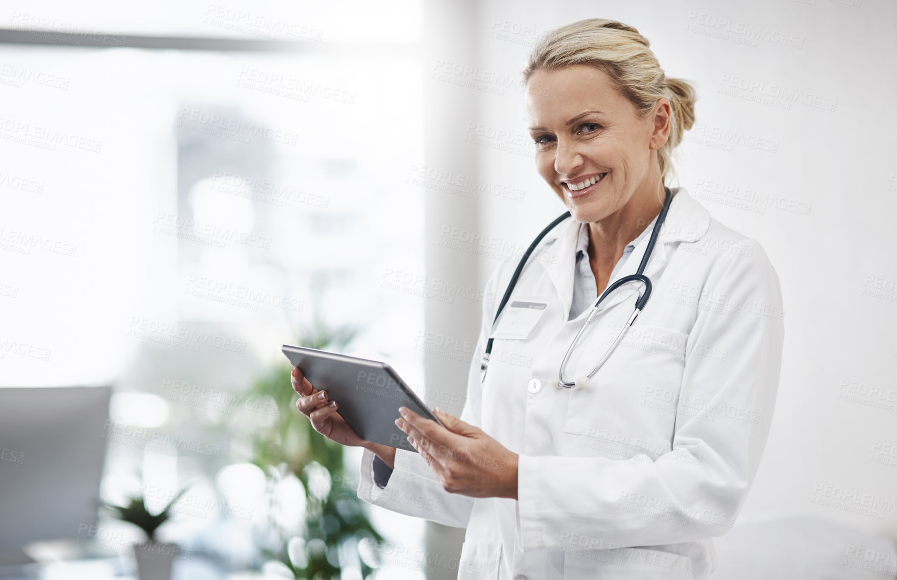 Buy stock photo Woman, doctor or portrait for healthcare with tablet, admin or research at hospital space. Mature cardiologist, smile or tech in practice for client info, telehealth or online registration platform