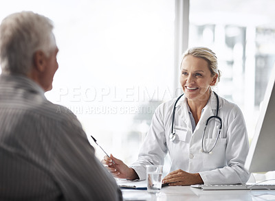 Buy stock photo Cropped shot of a mature female doctor working with a senior male patient in her office in the hospital