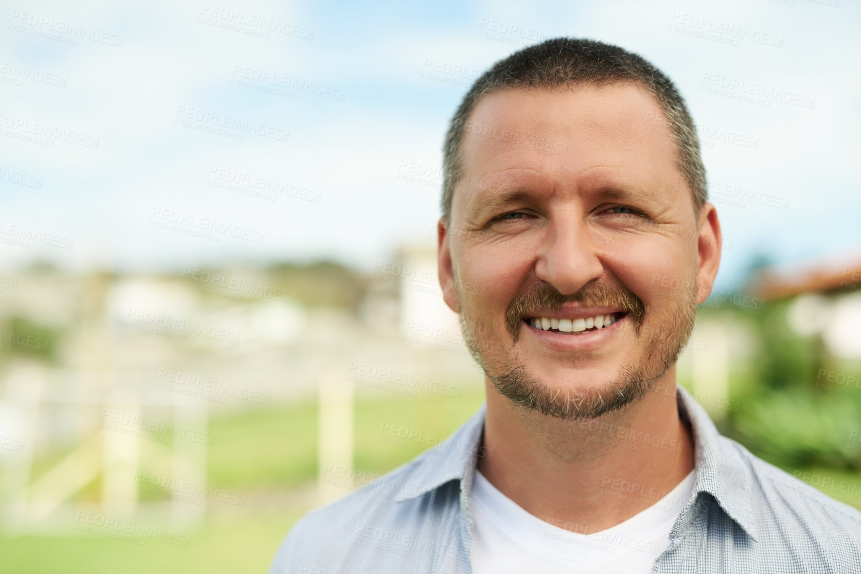 Buy stock photo Cropped portrait of a handsome man in the backyard at home