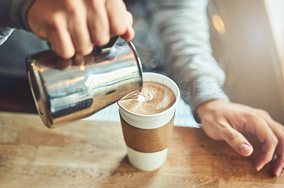 Buy stock photo Closeup shot of an unrecognizable barista pouring milk into a cup of freshly brewed coffee in a cafe