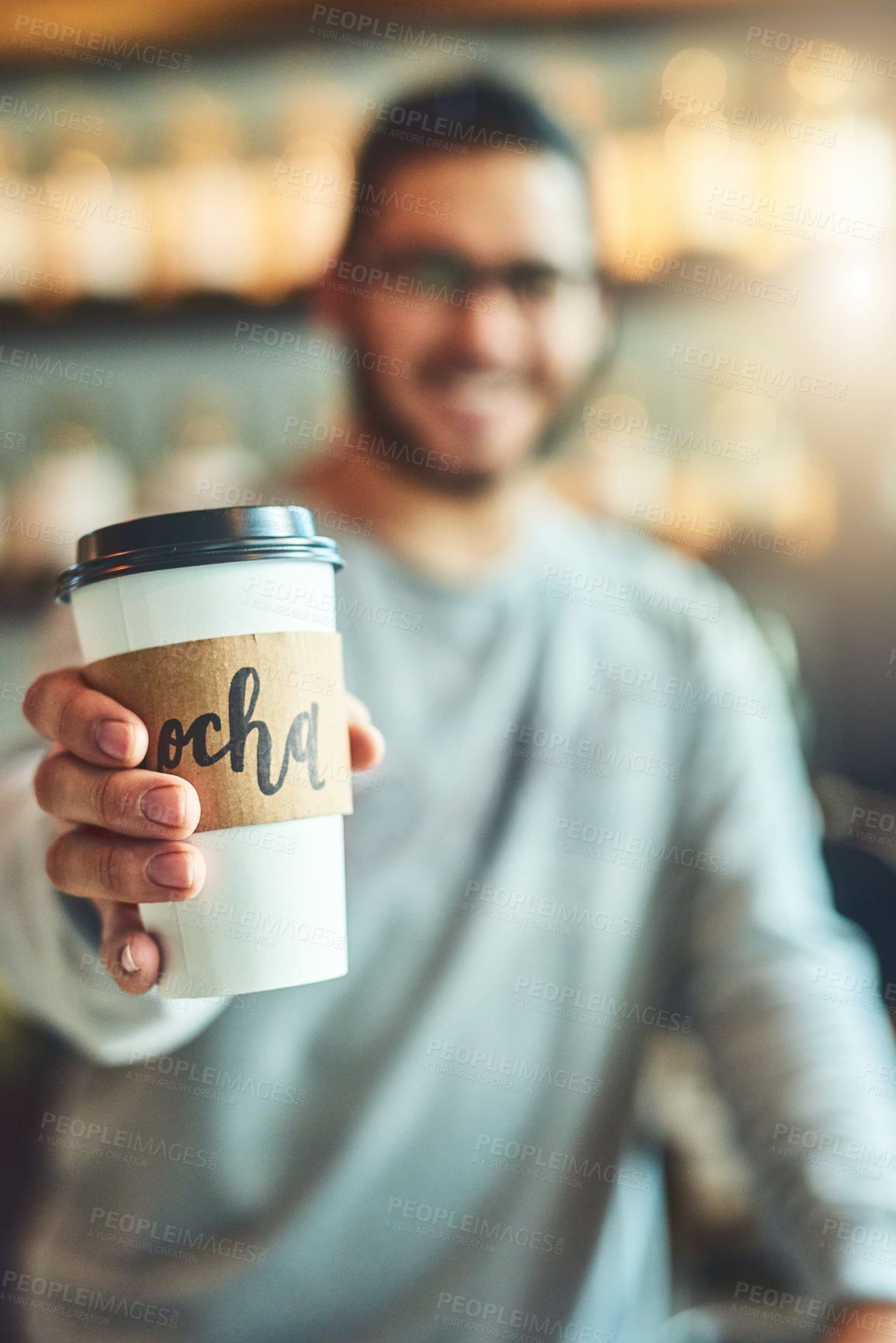 Buy stock photo Shot of a barista holding a cup of coffee in a cafe
