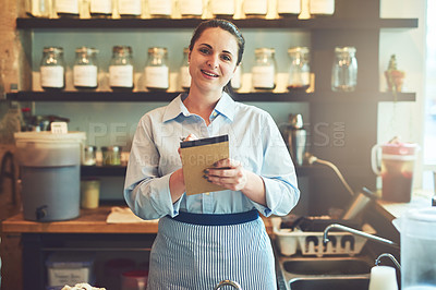 Buy stock photo Portrait of a young waitress holding a notebook in a cafe