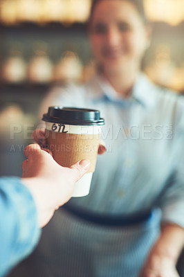 Buy stock photo Shot of a customer taking a cup of coffee from a barista in a cafe
