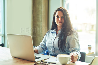 Buy stock photo Portrait of a young woman using a laptop in a cafe