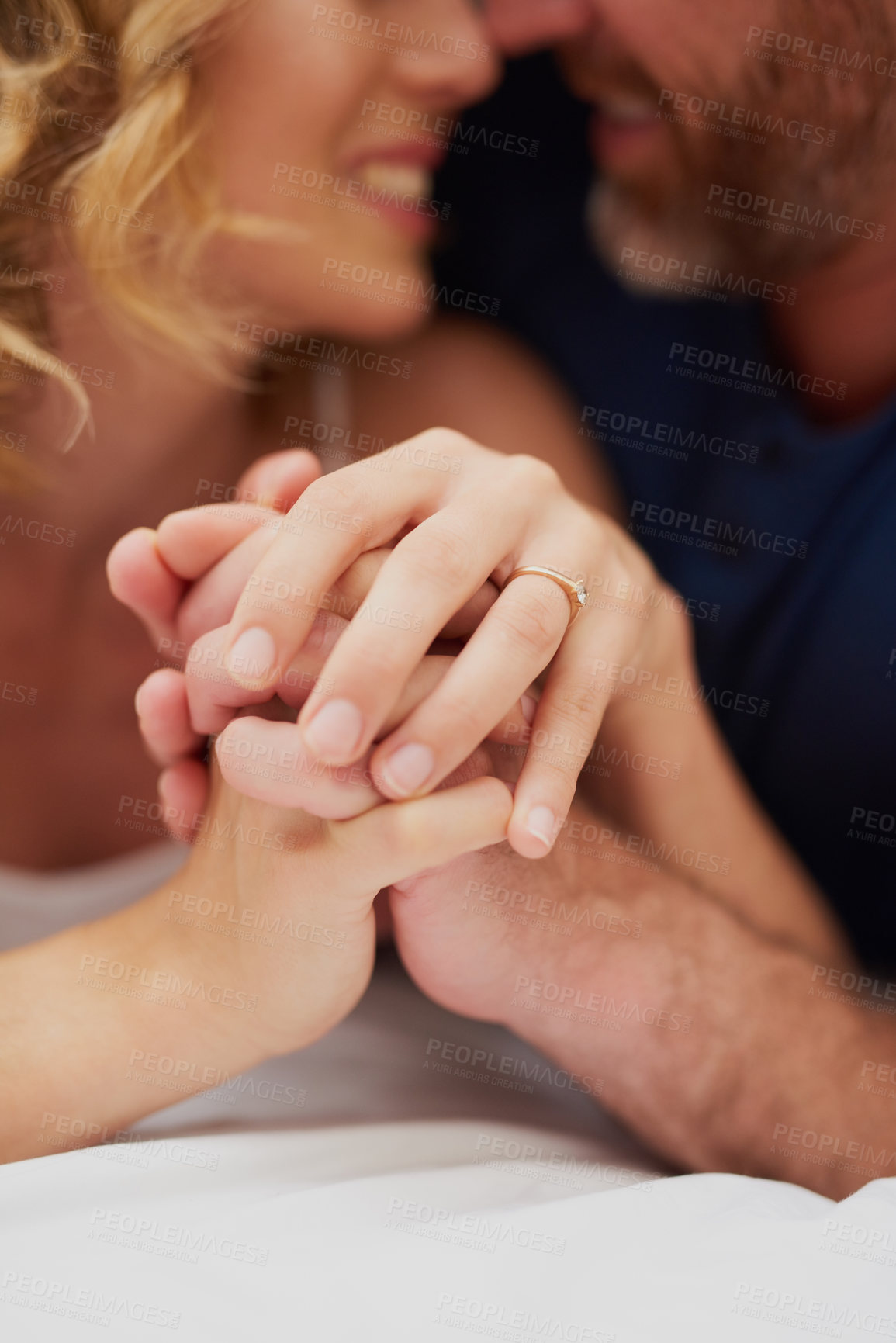 Buy stock photo Holding hands, bedroom and couple with love, house and bonding together with happiness, care and joy. Apartment, bed and man with woman, closeup and romance with marriage, honeymoon and relationship