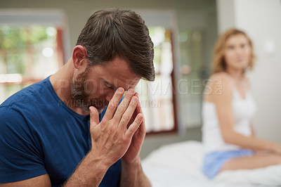 Buy stock photo Shot of a mature couple having marital problems in the bedroom at home