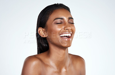 Buy stock photo Studio shot of a beautiful young woman posing against a light background