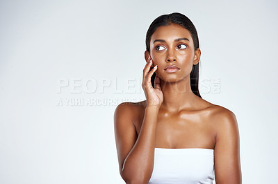 Buy stock photo Indian woman, skincare and thinking for beauty cosmetics on white background, mockup or dermatology. Female person, model and healthy wellness with makeup confidence for self care, studio or shine