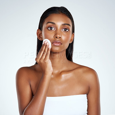 Buy stock photo Indian woman, portrait and cleaning with cotton pads in studio or cleansing, makeup or removal. Female person, face and dermatology on white background with healthy pores, benefits or mockup space