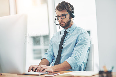 Buy stock photo Shot of a young man working in a call center