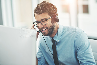 Buy stock photo Shot of a happy young man working in a call center