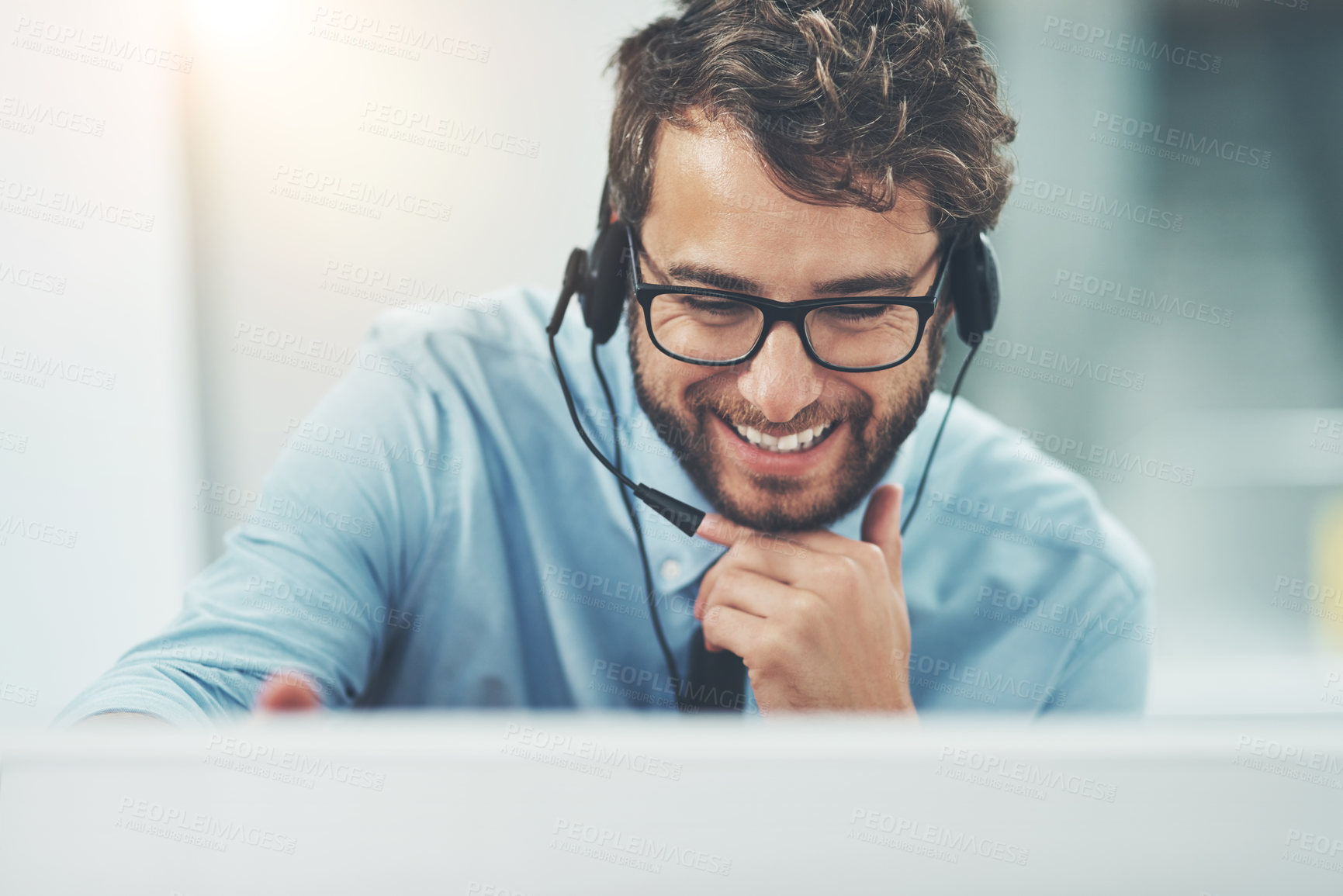 Buy stock photo Shot of a happy young man working in a call center