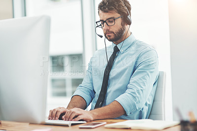 Buy stock photo Shot of a young man working in a call center