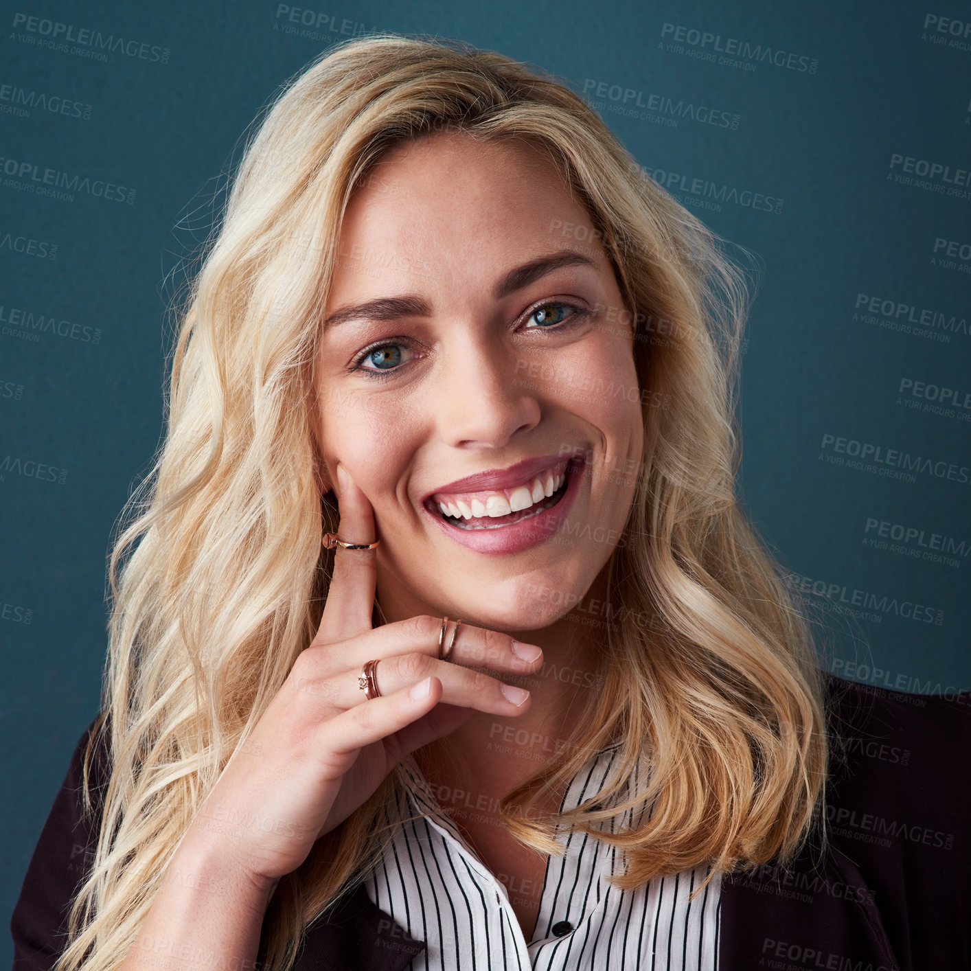 Buy stock photo Studio shot of a beautiful young businesswoman posing against a blue background