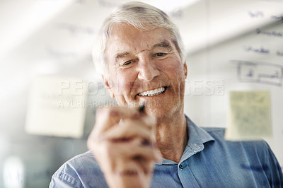 Buy stock photo Cropped shot of a senior businessman writing down ideas with a pen marker on a glass wall in the office