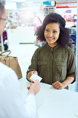 Buy stock photo Cropped shot of an attractive young female customer buying medication in a pharmacy
