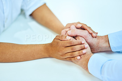Buy stock photo High angle shot of two unrecognizable people holding hands in comfort