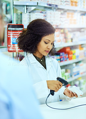 Buy stock photo Cropped shot of an attractive young female pharmacist helping a male customer in the pharmacy
