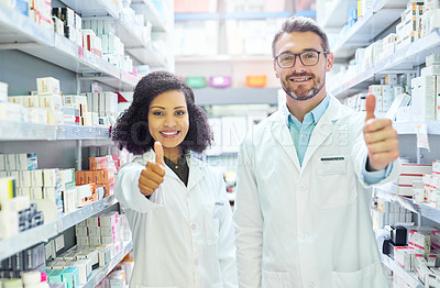 Buy stock photo Portrait of a confident mature man and young woman showing thumbs up in a pharmacy