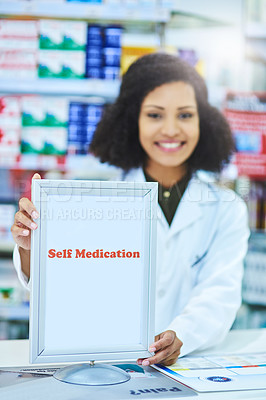 Buy stock photo Shot of a young woman showing a self medication sign at the counter of a pharmacy