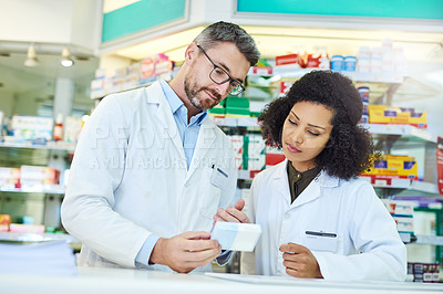 Buy stock photo Man, woman and reading box in pharmacy for prescription drugs, ingredients or medical benefits of pills. Healthcare, pharmacist and consultant checking info on medicine for advice, decision or choice